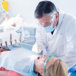 dentist-examining-a-patients-teeth-in-the-dentists-chair service nine